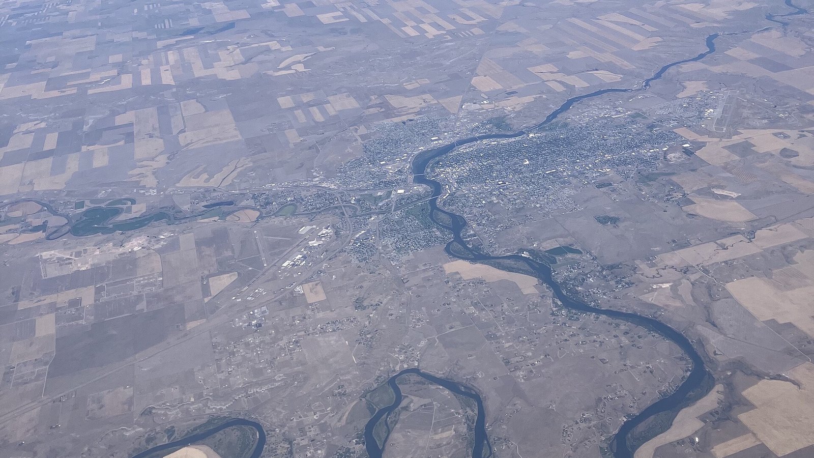 Aerial view of the Missouri River winding past Great Falls, Montana, and surrounding farmland